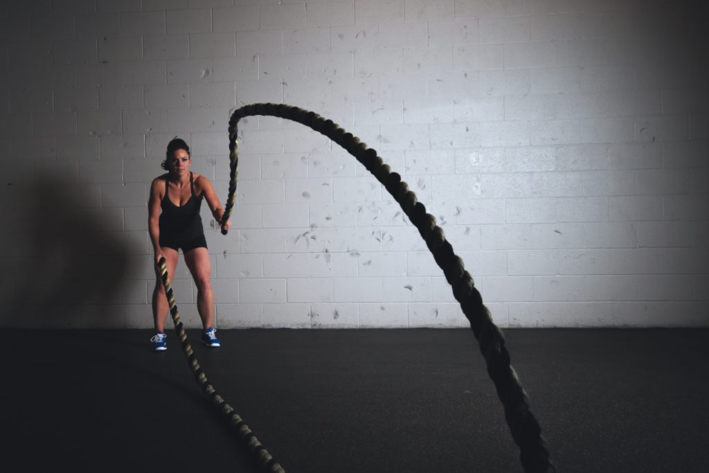 A woman training on heavy ropes