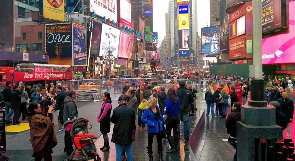 Technical Penguins: A photo of Times Square in NYC shows a lot of billboards and people milling around.