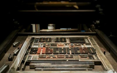 Technical Penguins Guide to the WordPress Gutenberg Editor: A photo of a printing plate, with letters typeset, sitting on a press.